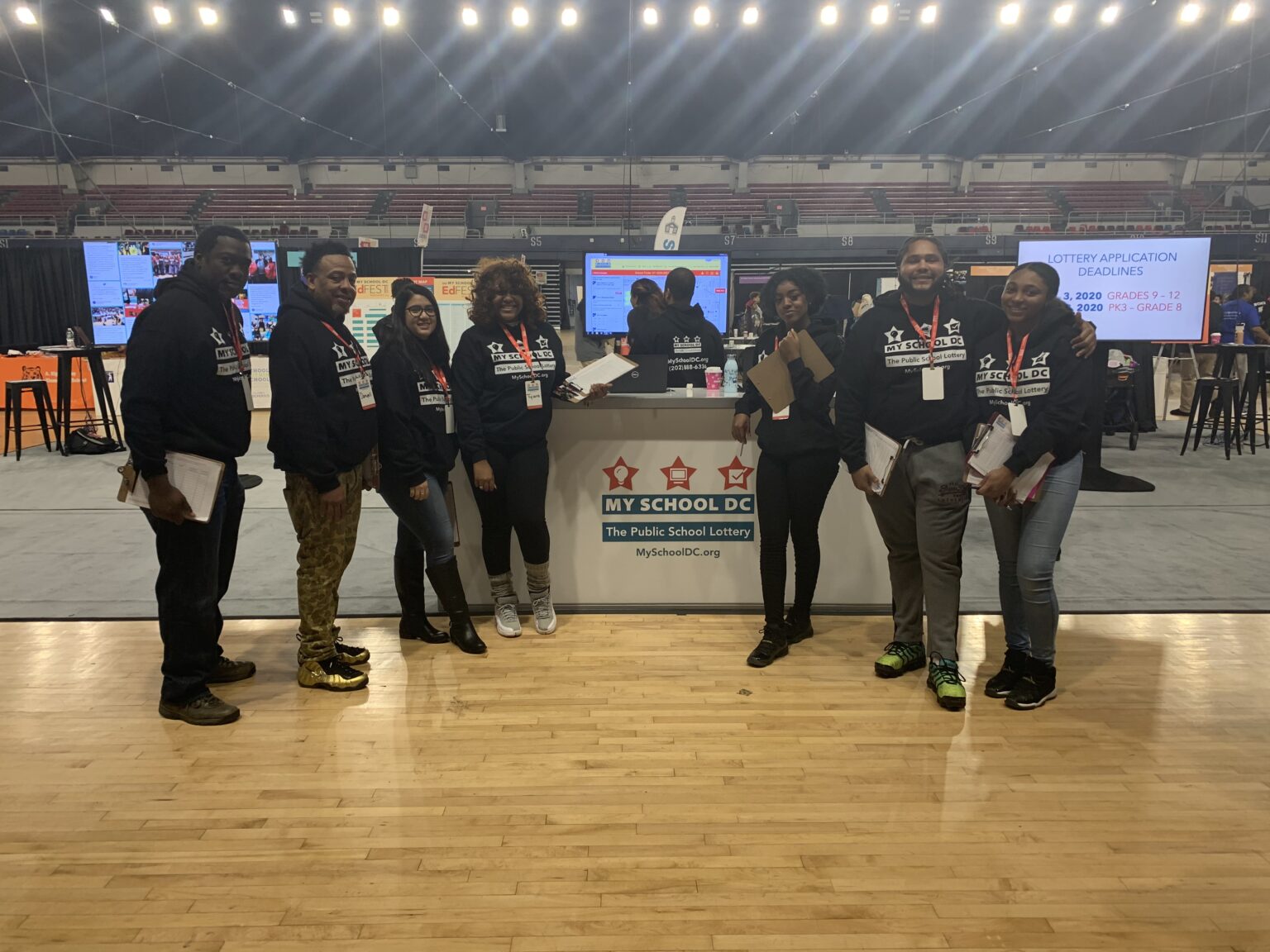 A group of people standing in front of a stage.