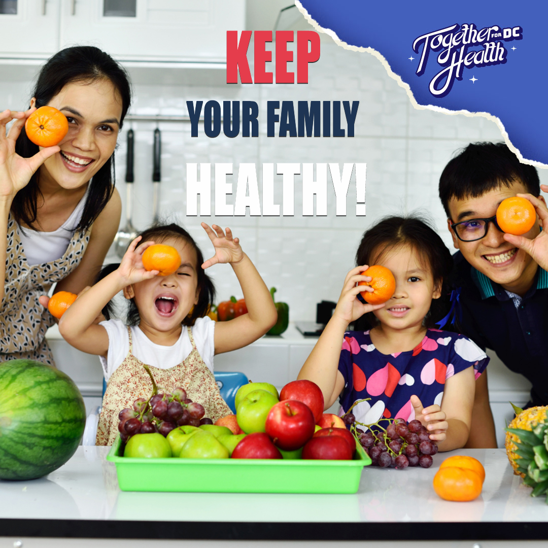 A family is eating fruit in the kitchen.