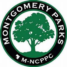 A black and white logo of the montgomery parks.